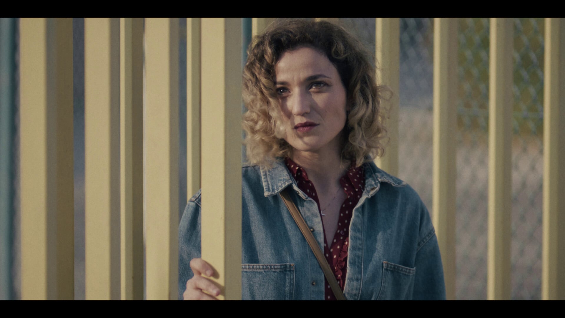 A woman looks on from a doorway in a scene from the film